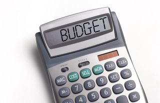 A calculator has the word 'Budget' written on the screen.