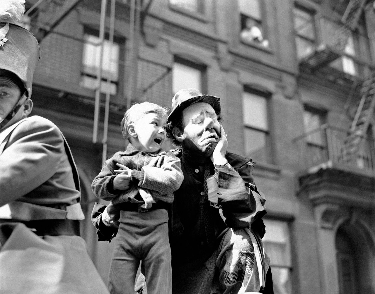 Three-year-old Richard Caglione sheds tears as a stranger, in this case, Emmett Kelly, featured clown with Ringling Brothers and Barnum and Bailey Circus, picks him up.