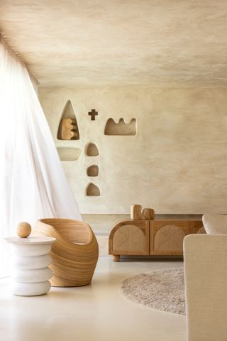 a limewash living room with organic shape niches and furniture