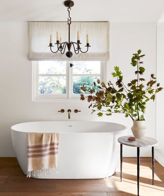 Montecito freestanding bath with chandelier and white walls