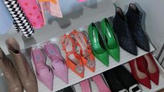 bright designer shoes in row on closet shelf