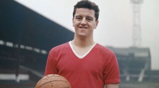 MANCHESTER, ENGLAND - JANUARY 01: Manchester United player Tommy Taylor, one of the Busby Babes pictured in his United kit holding an orange match ball circa 1957 in Manchester, United Kingdom. (Photo by Don Morley/Allsport/Getty Images/Hulton Archive)
