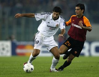 Luis Figo of Real Madrid holds off Josep Guardiola of Roma during the UEFA Champions League First Phase Group C match between AS Roma and Real Madrid at the Stadio Olimpico in Rome, Italy on September 17, 2002. Real Madrid won 3-0.
