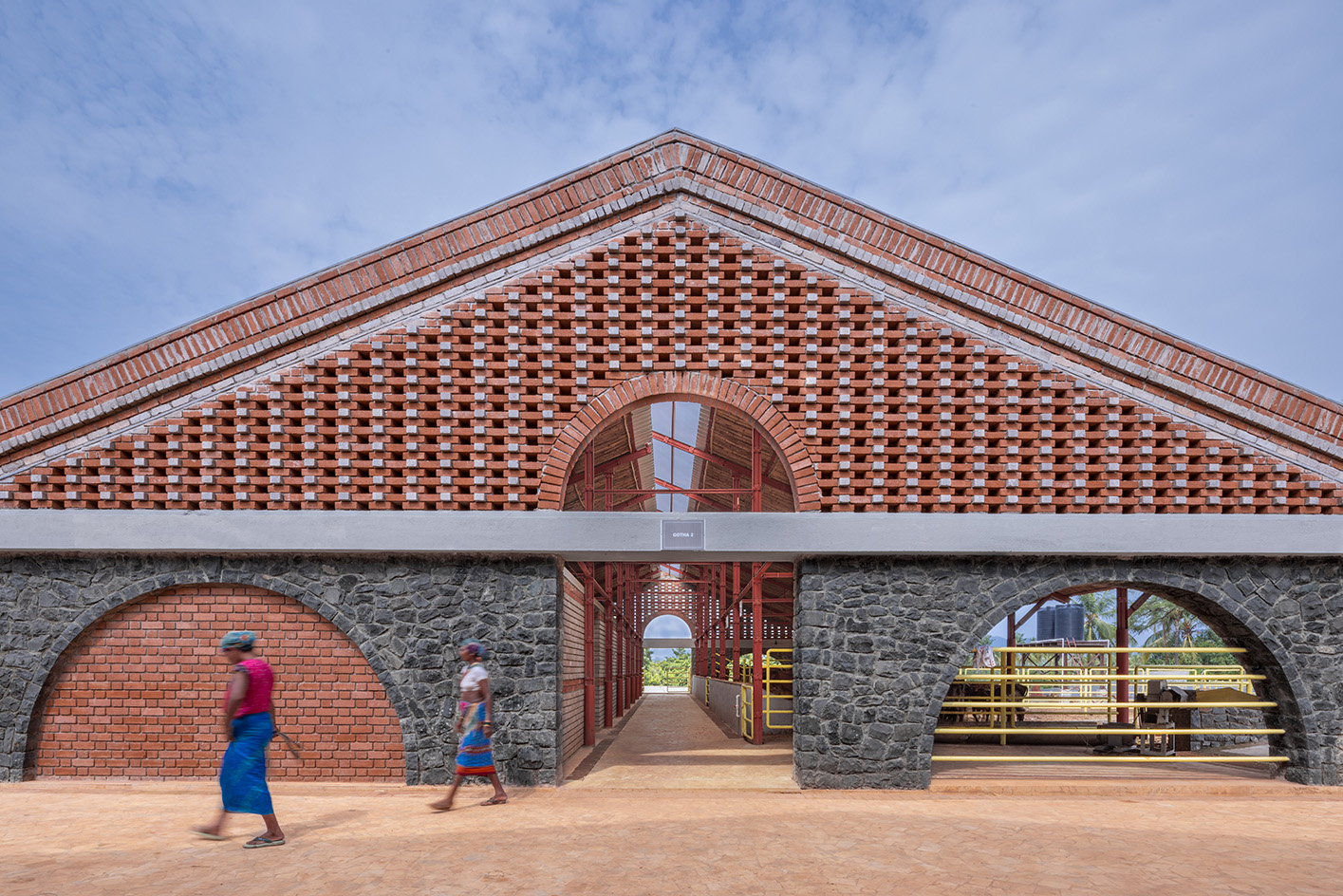 Gaugram , a cow shelter with pitched roofs and brick structure
