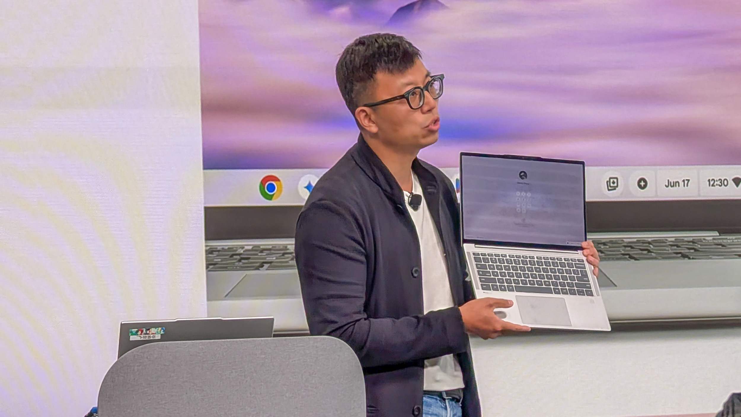 Benny Zhang, Executive Director and General Manager of Chromebooks at Lenovo , holding the Lenovo Chromebook Plus 14 open