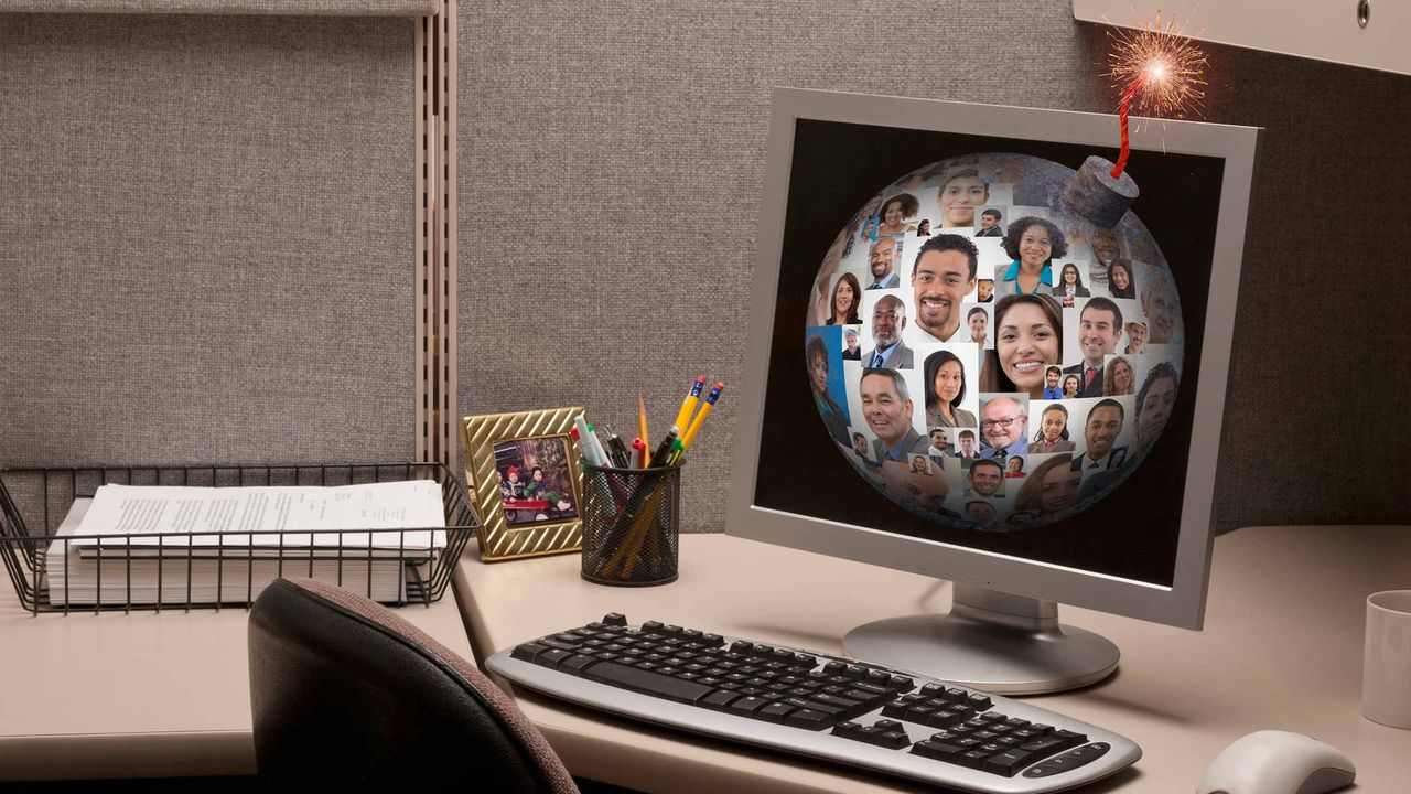 A work cubicle with a time bomb on the computer screen.