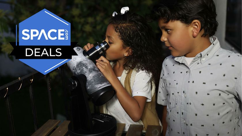 Two children using the Celestron Firstscope at night. 