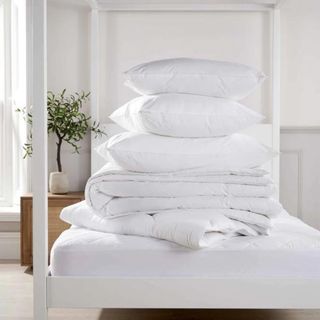 Pillows sitting on a pile of bed sheets