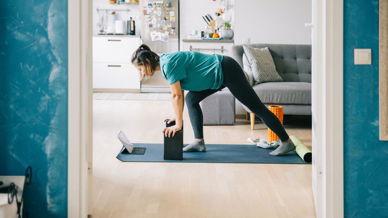 Woman doing workout at home with yoga blocks