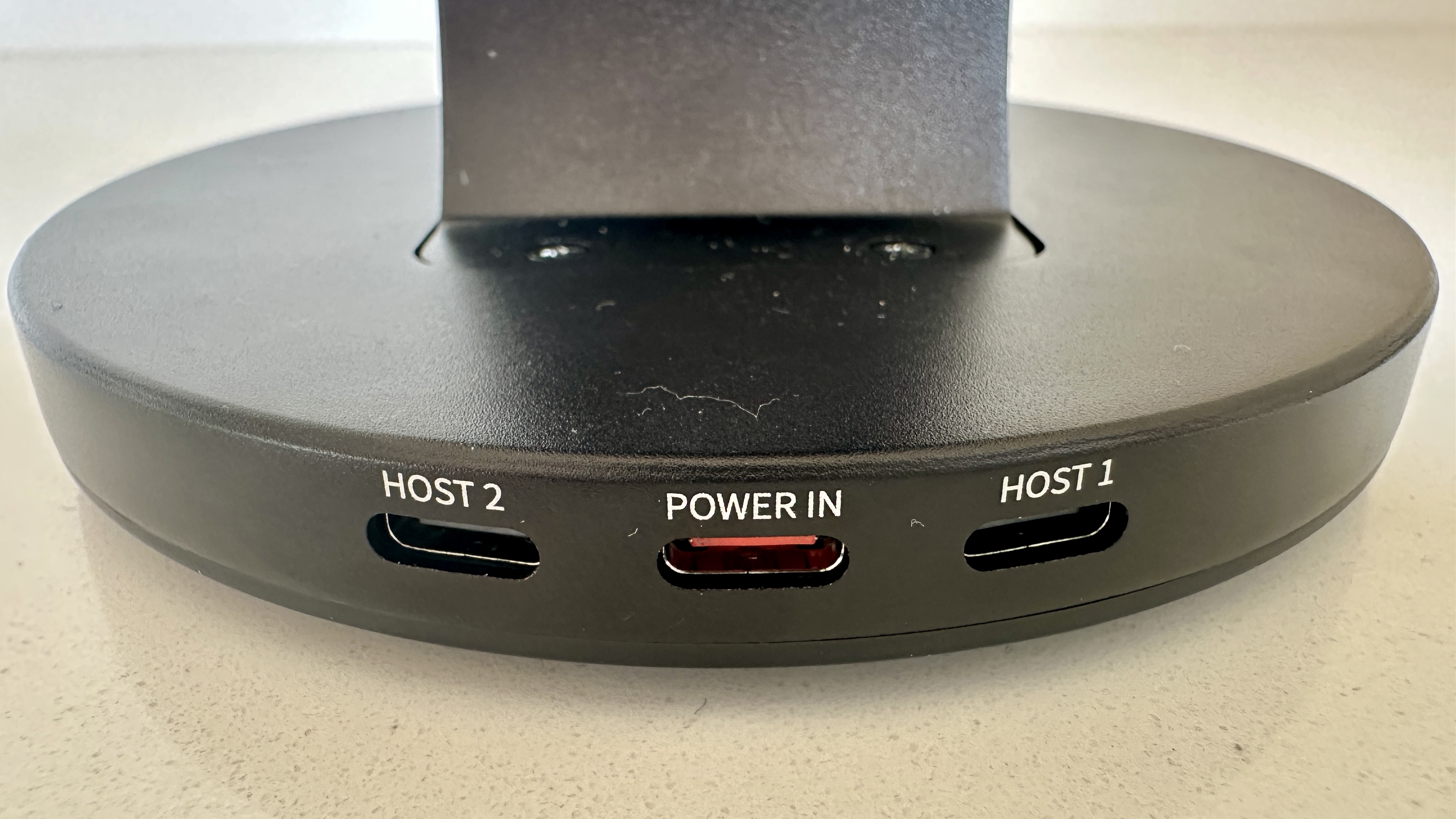 The FiiO M27 player with screen and dial showing, and content on the screen, on beige or yellow background