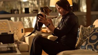 Keanu Reeves hold a puppy in John Wick