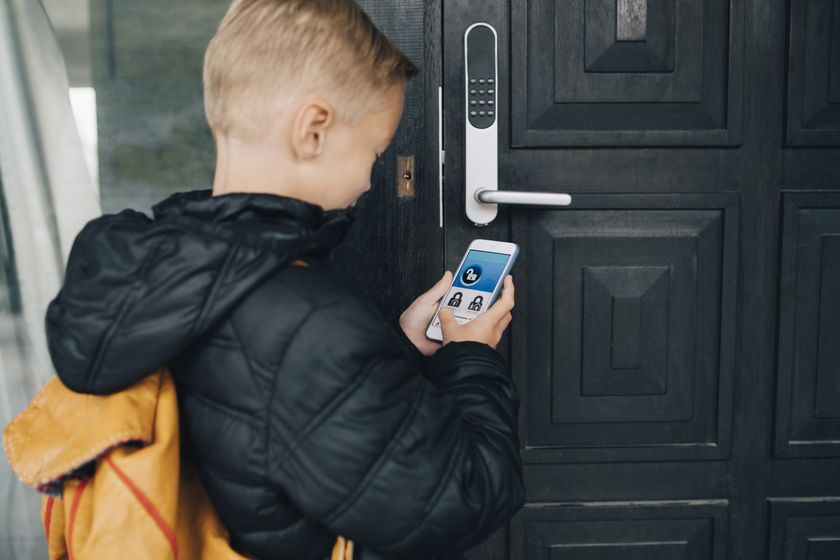 a child using an app to unlock his home's front door