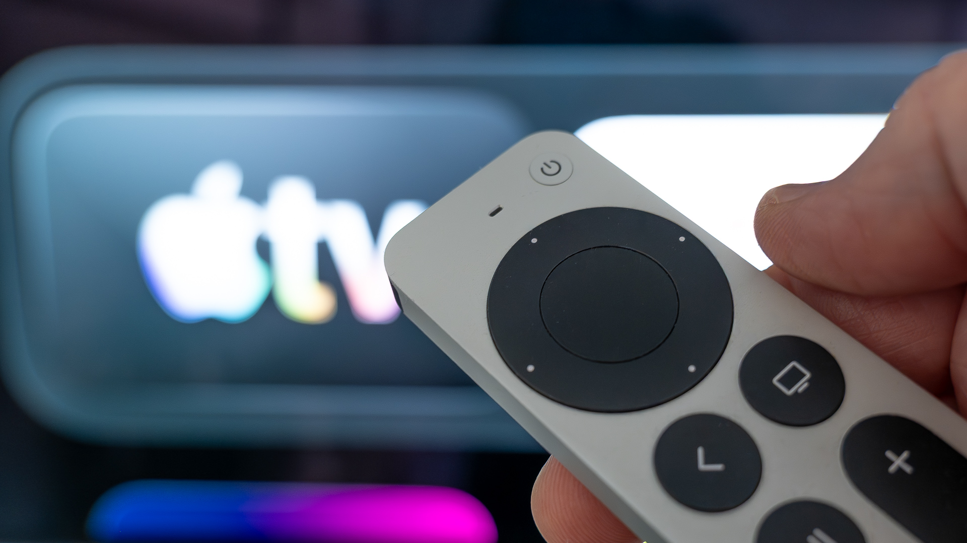 Apple TV 4K remote control pointing at Apple TV app