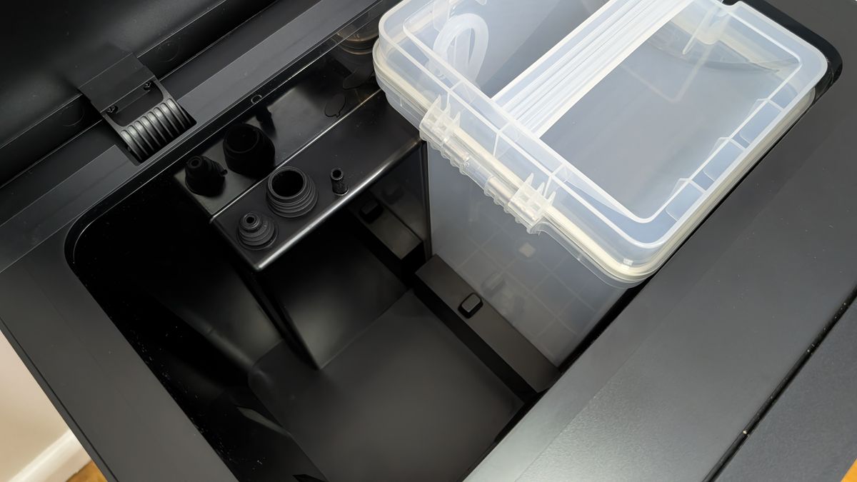 Dreame Matrix10 Ultra base station showing close up of the clean and dirty mop water containers, with one removed