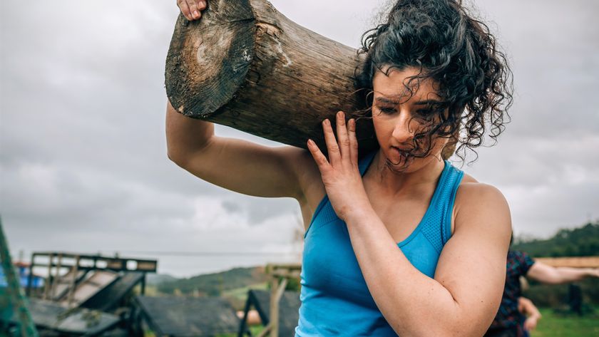a woman carrying a log over her shoulder