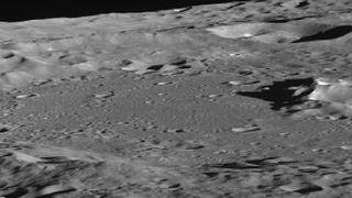 close-up view of a crater on the moon, with the blackness of space in the background