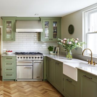 sage green kitchen with steel range cooker and belfast sink