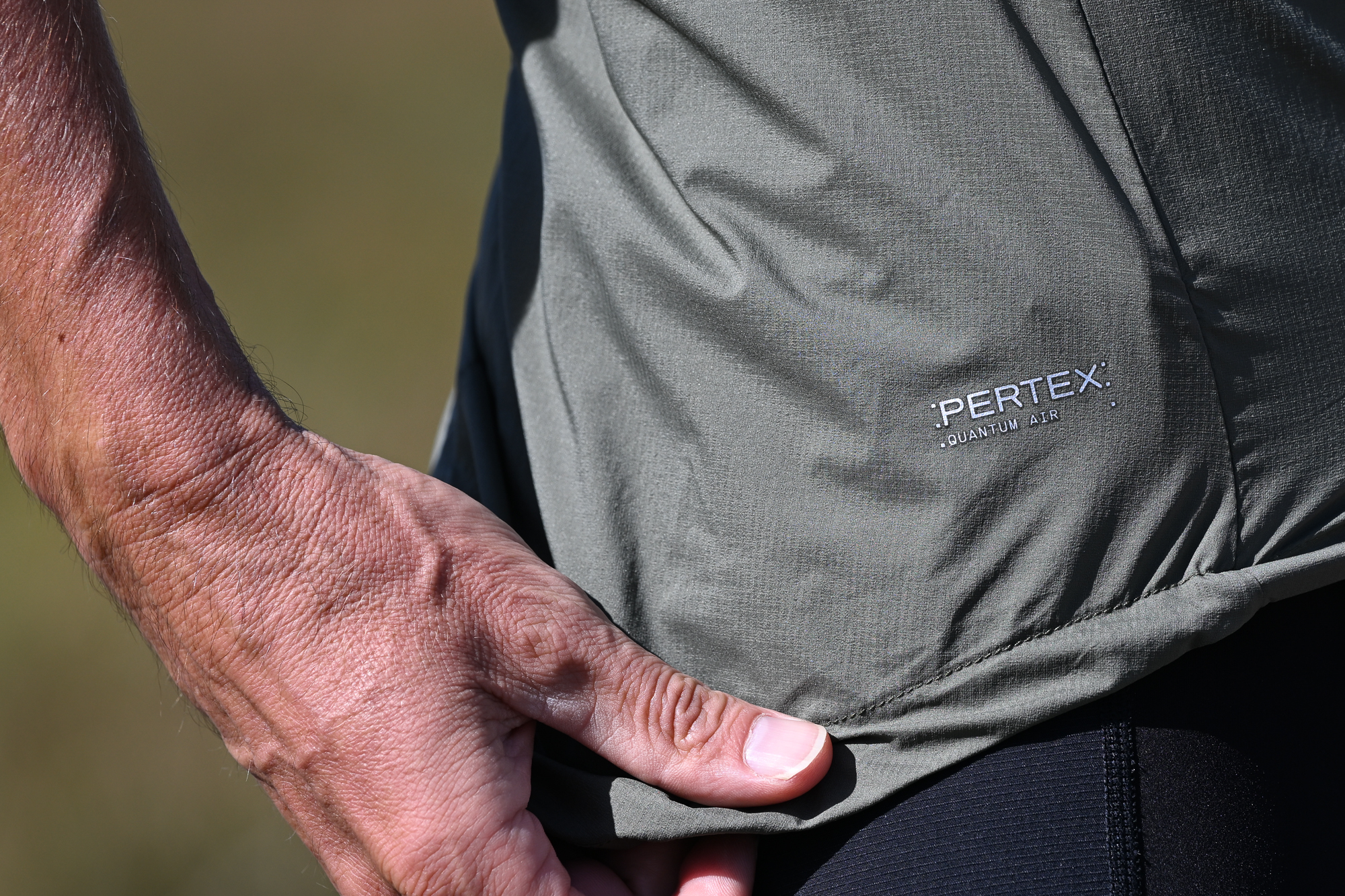 close up of the Pertex Quantum Air branding on a green cycling gilet