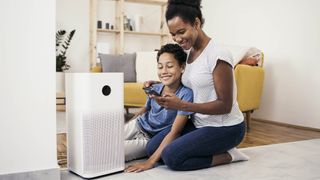 woman and boy using air purifier