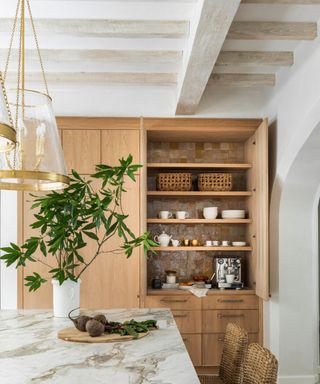 Wooden kitchen with white marble countertops and rustic fixtures