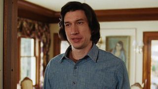 Adam Driver stands smiling in his home in Marriage Story