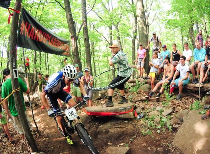 Carl Decker (Team Giant) rides past Hula-Hoop Man