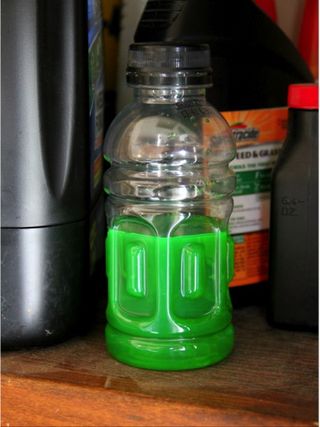 A bottle containing brightly colored antifreeze, which can look like an inviting treat to a young child.