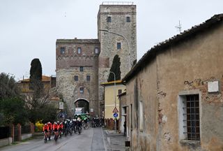 The peloton riding through a town on stage three of Tirreno-Adriatico 2025