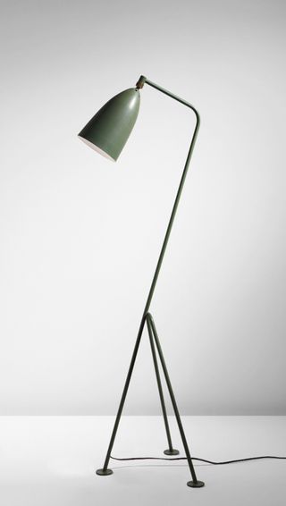 Floor lamp with three slim legs and a green lampshade by Greta Grossman