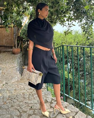 Fashion influencer Sandra Shehab wearing a ruched neckline Jacquemus top.