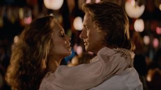 Joan Wilder (Kathleen Turner) and Jack T. Colton (Michael Douglas) prepare to share a kiss after dancing in Romancing the Stone.