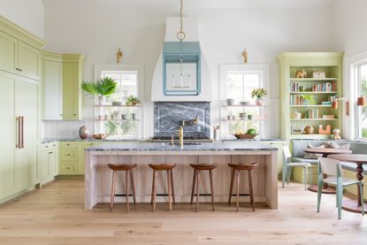 green country kitchen with wooden kitchen island marble worktop and seating