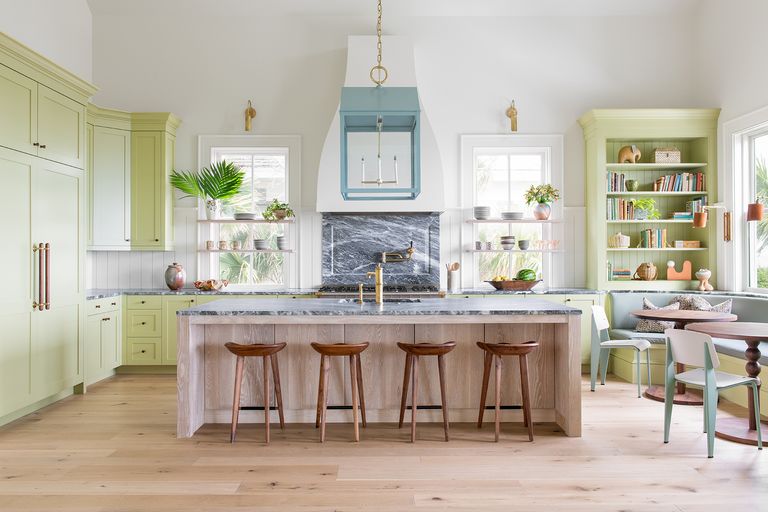 green country kitchen with wooden kitchen island marble worktop and seating
