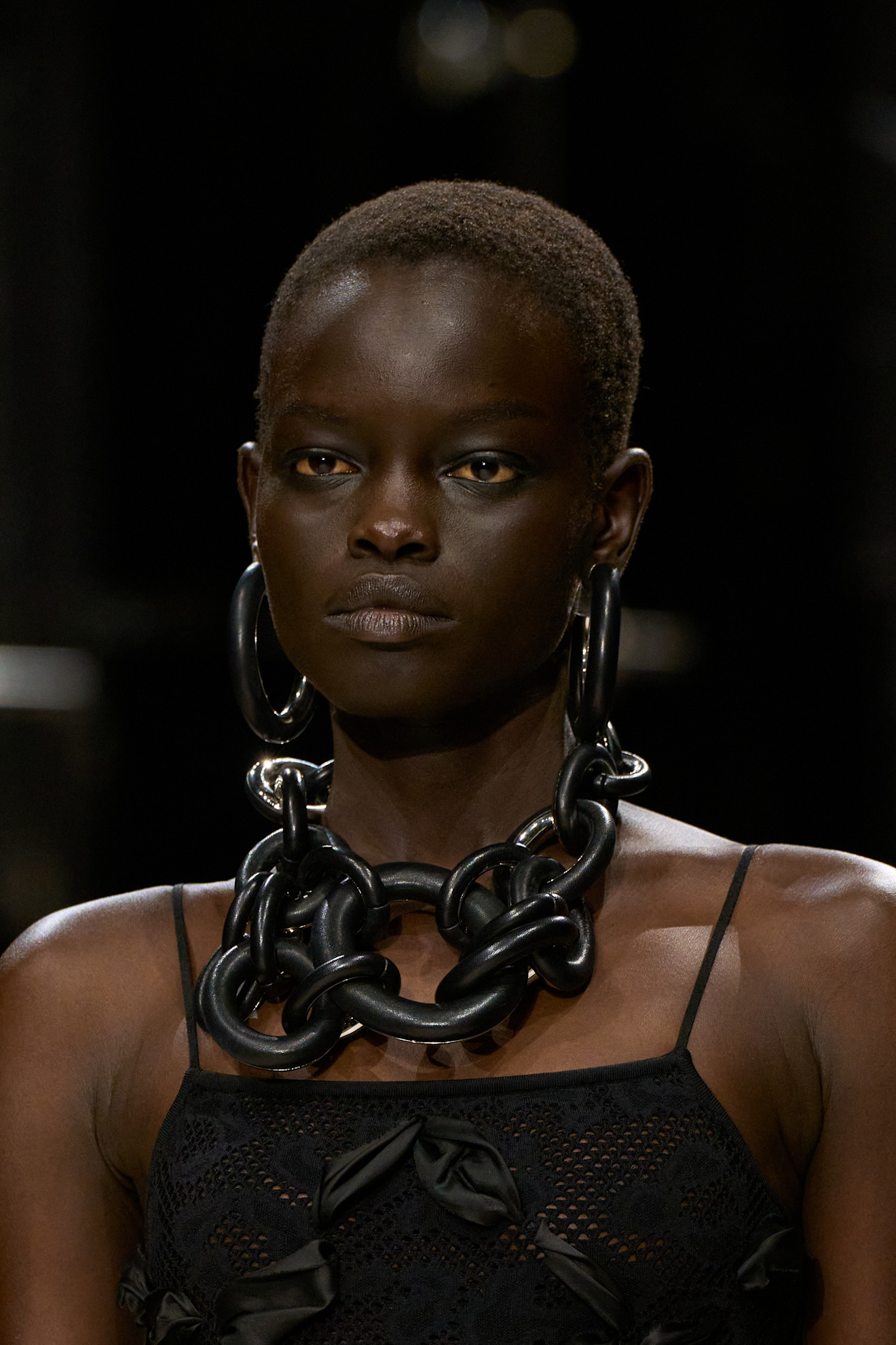 a givenchy model wears oversize jewelry on the fall/2026 runway