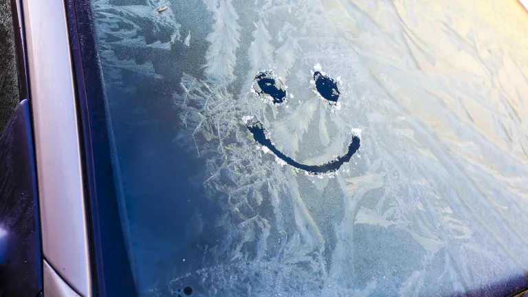 A smiley face on a frosted window