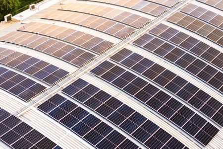 Modern Solar Panels Installed on Curved Industrial Roof