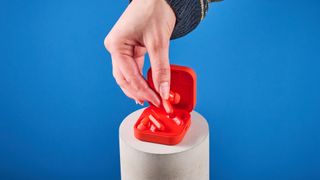 the nothing cmf buds pro 2 cmf by nothing buds pro 2 in bright orange shown in the smart dial charging case against a blue tom's guide background