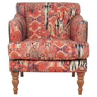 wooden armchair with printed cushions