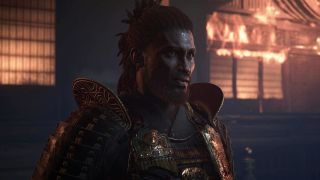 Assassin's Creed Shadows Yasuke unlock - An upper-body shot of Yasuke standing outside a burning building.