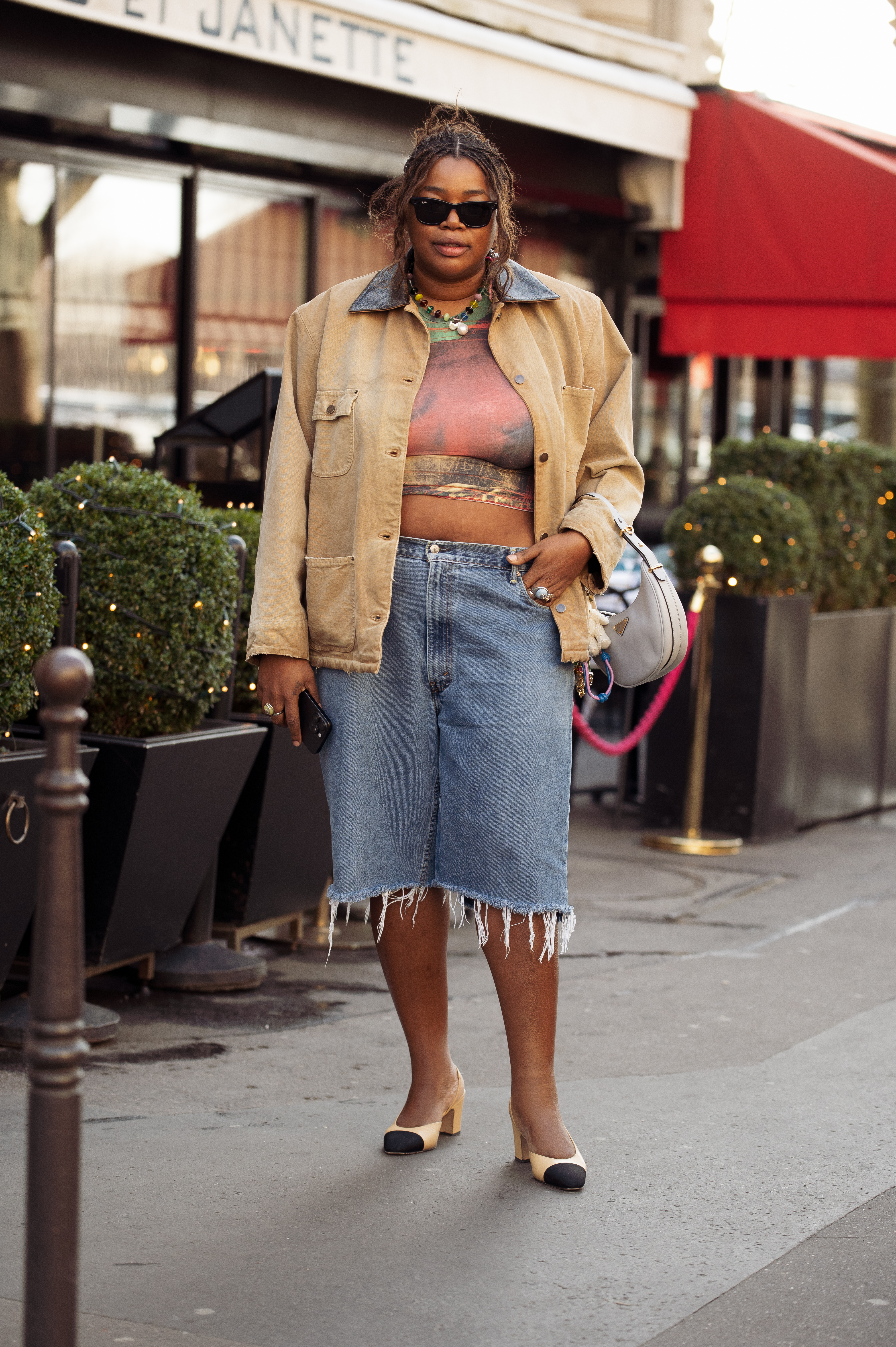 Woman in long denim shorts and barn jacket