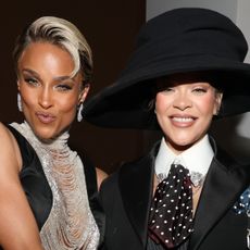 Ciara in a black and silver gown and Rihanna in a suit and black large hat at the 2025 Met Gala 