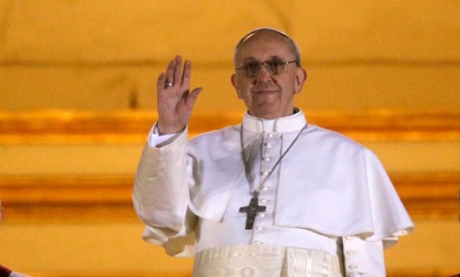 The new Pope Francis waves to his supporters from the balcony of St. Peter&amp;#039;s Basilica at the Vatican on March 13.