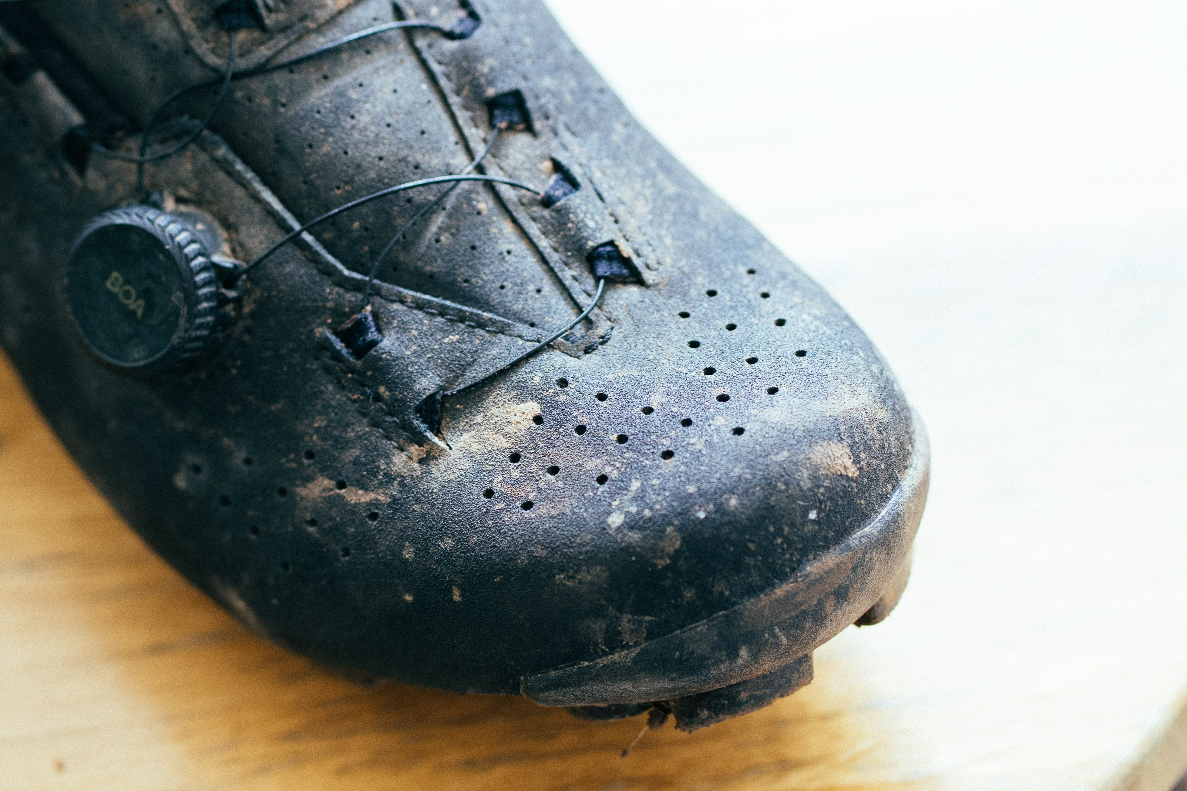 A close up of the textured leather toe of a black gravel shoe