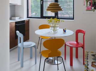 a small apartment dining room with a bruno rey chair around the table