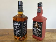 A Jack Daniel's bottle and knockoff dog toy. 