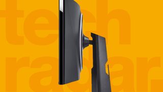 Side view of a TechRadar pick for best gaming monitor on a yellow background