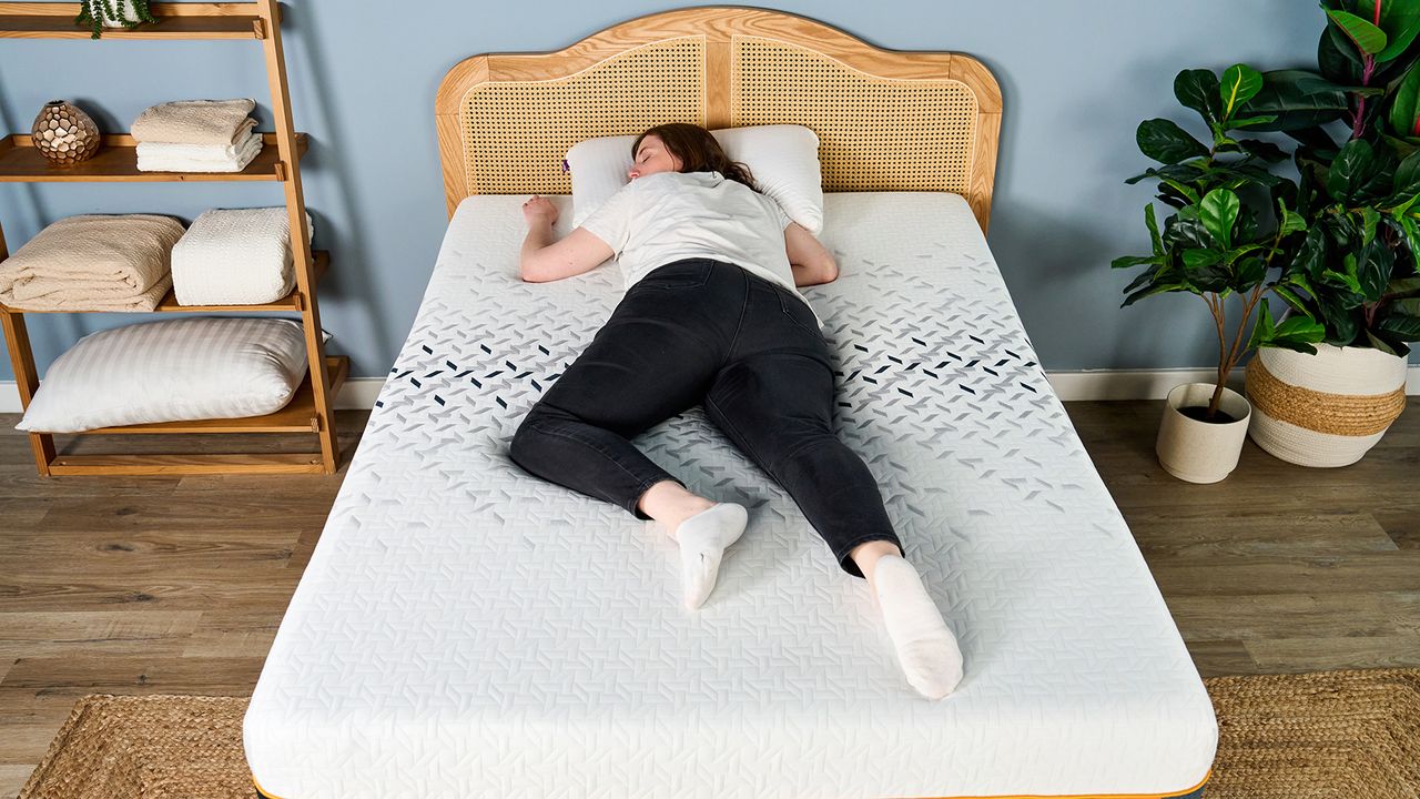 A female Tom's Guide mattress tester lying on her front on the Nectar Ultra Hybrid
