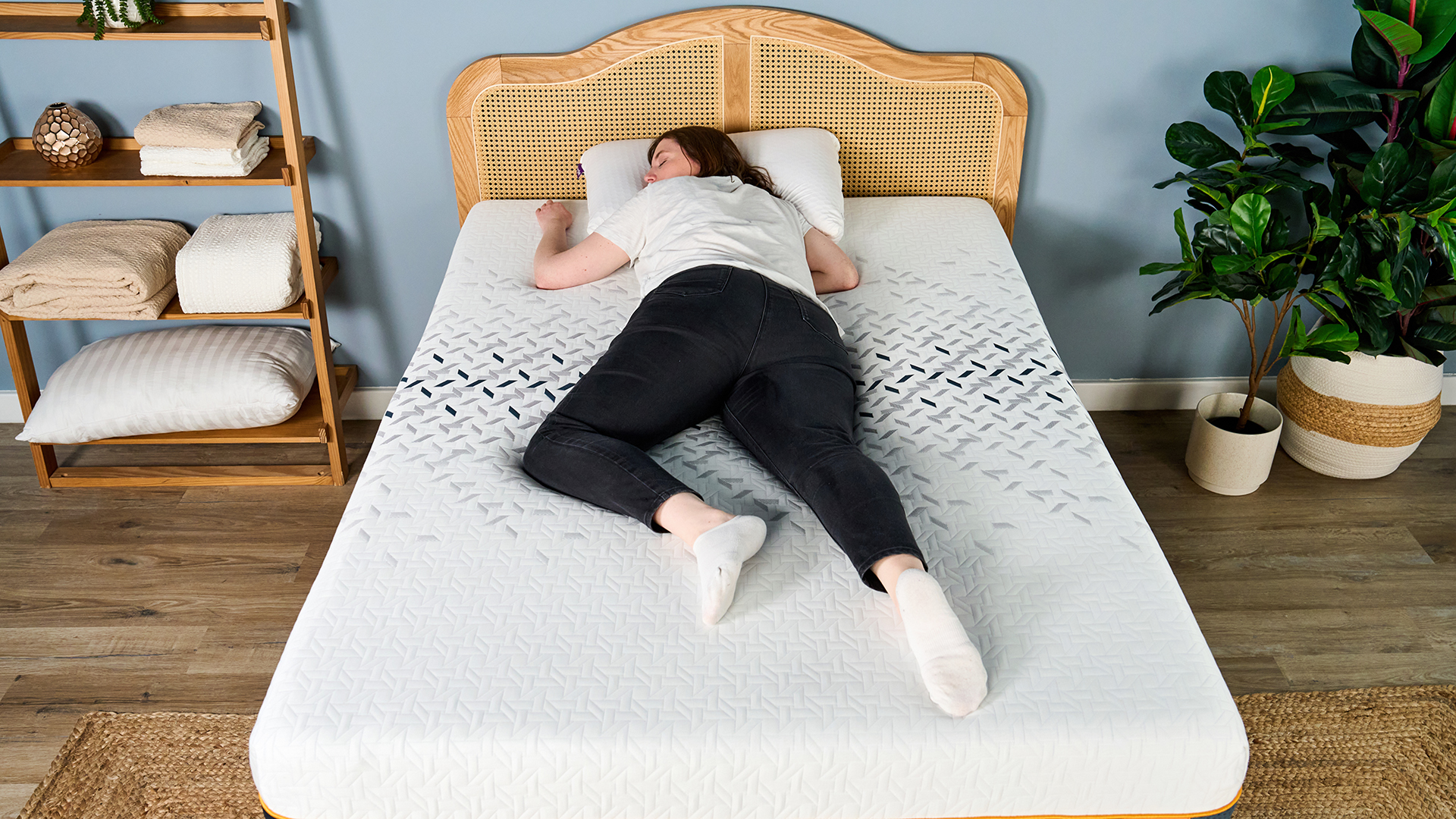 A female Tom's Guide mattress tester lying on her front on the Nectar Ultra Hybrid