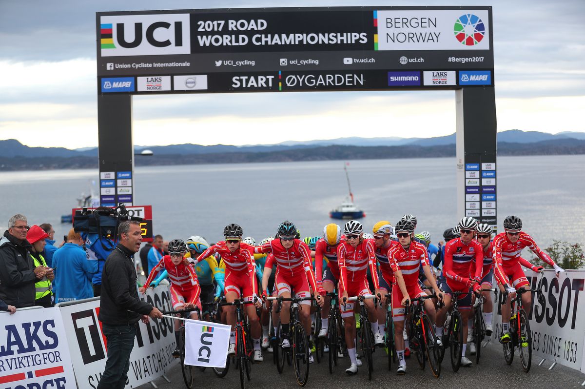 The Danish and Norwegian teams swarm to the front at the start of the race