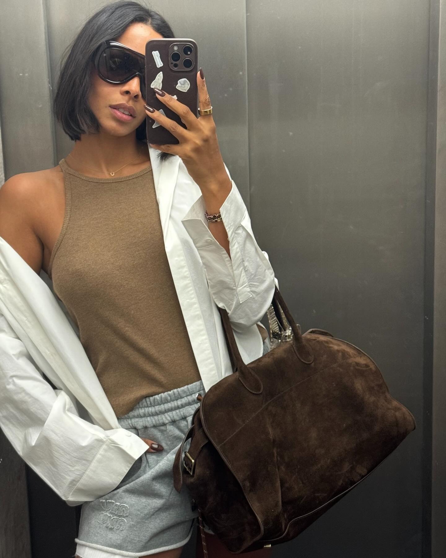 Rochelle Humes taking a selfie in an elevator with a choppy, disconnected bob haircut